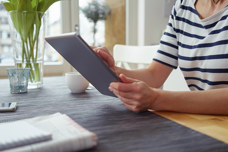 Woman Checking PDB's Newsletter in her Tablet