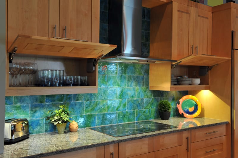 Induction cooktop and colorful tile backsplash in kitchen remodel by Progressive Design Build